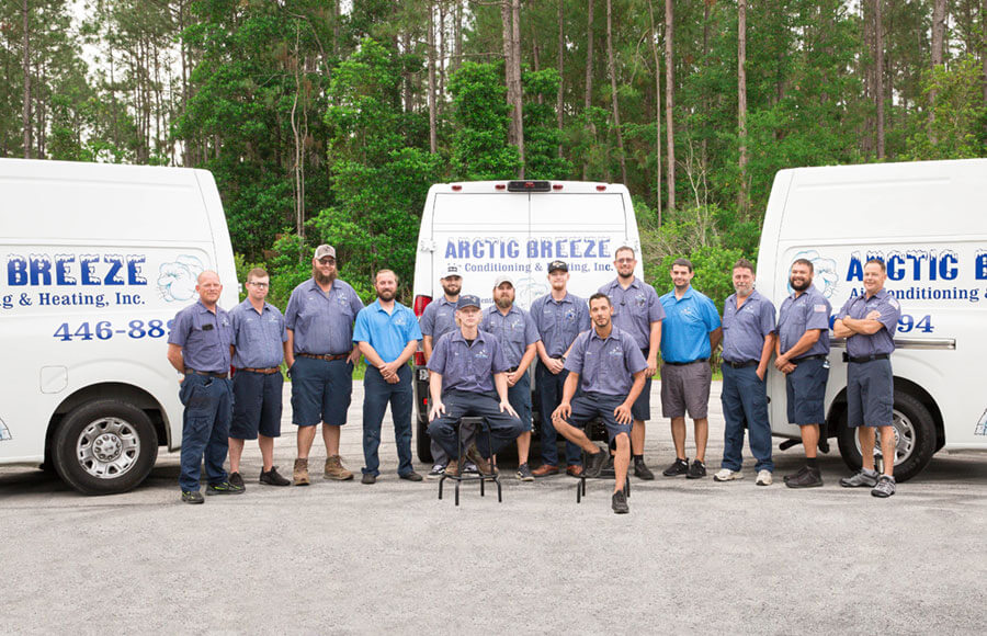 Arctic Breeze service team in from of service trucks