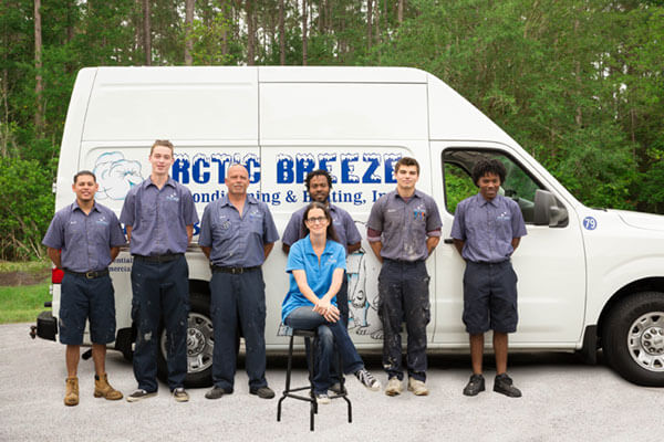 Arctic Breeze team in front of a service truck