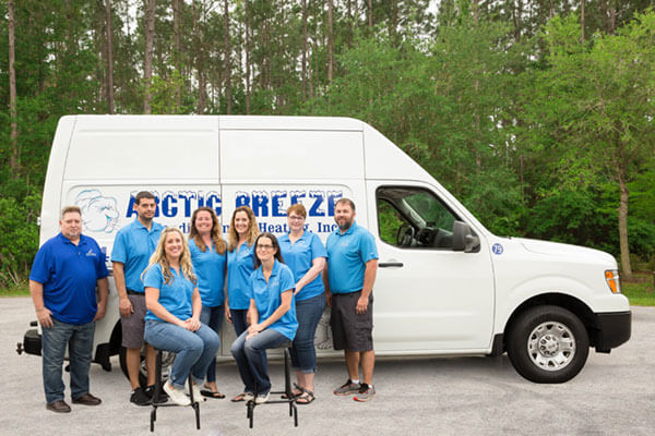 Arctic Breeze team in front of one of their service truck